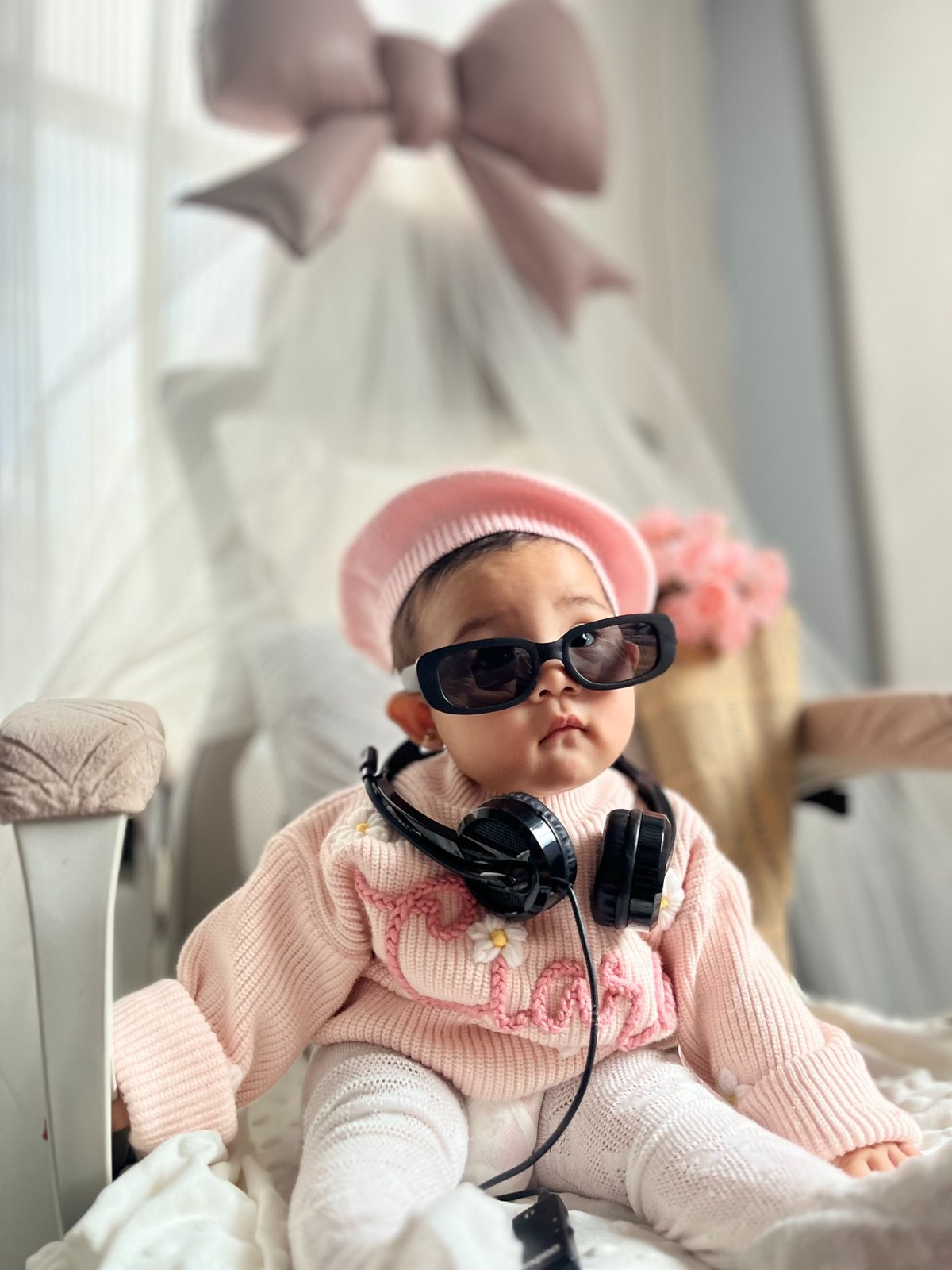 Ciara in a pink outfit with sunglasses and headphones